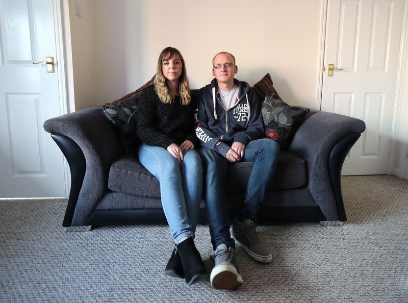 Claire Tomlinson and her partner Ricky Collier pose for a portrait in Sandbach