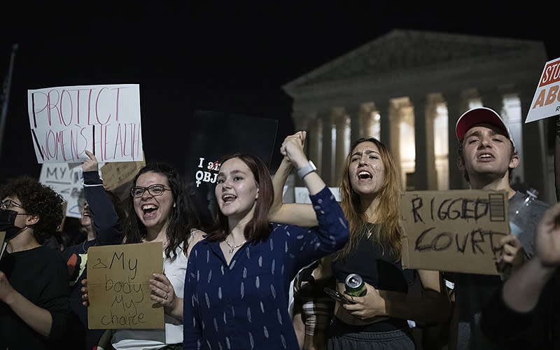 Following the leak of a Supreme Court draft that could overturn Roe v. Wade, protesters gather in the middle of the night in front of the Supreme Court in Washington, D.C., on May 3. <em>Anna Rose Layden</em>