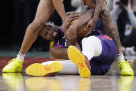 Phoenix Suns forward Kevin Durant, bottom, fights for a loose ball with San Antonio Spurs forward Jeremy Sochan during the second half of an NBA basketball game in San Antonio, Monday, March 25, 2024. (AP Photo/Eric Gay)