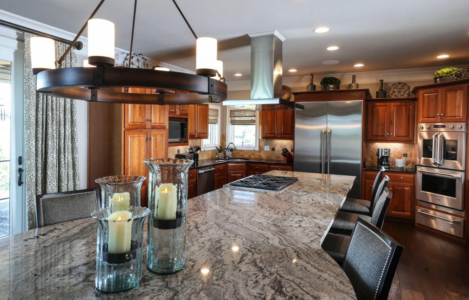 The large kitchen in the Kelley home features a large island with stove as well as room for several to sit. Tile and a wood floor complete a cozy look to the large space.