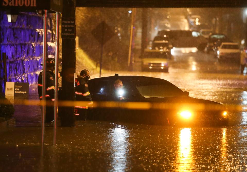 Wilmington firefighters assist motorists who were stranded in a car in high water at 14th and Scott Streets in Trolley Square after heavy rains overwhelmed storm drains in 2020.