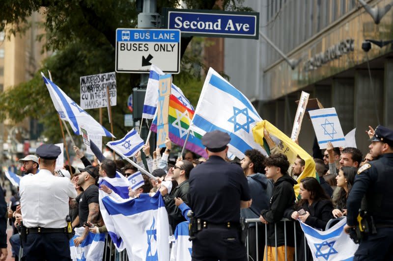Israel supporters hold flags standing on Second Avenue at an Emergency Rally for Gaza event on Monday in New York City. Israel's military is trying to gain control of all communities around Gaza more than 2 days after Hamas launched a surprise assault in which more than 700 people were killed. Photo by John Angelillo/UPI