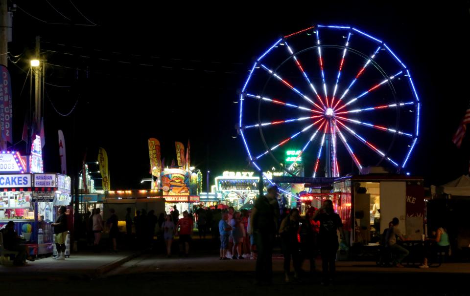 People enjoy the rides and food after the rodeo at the Central Kansas Free Fair Wednesday evening, August 3, 2022, in Eisenhower Park in Abilene.