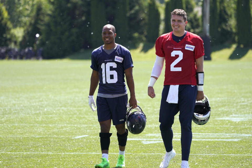 Seattle Seahawks quarterback Drew Lock (2) walks with wide receiver Tyler Lockett (16) after NFL football practice Tuesday, May 31, 2022, in Renton, Wash. (AP Photo/Ted S. Warren)
