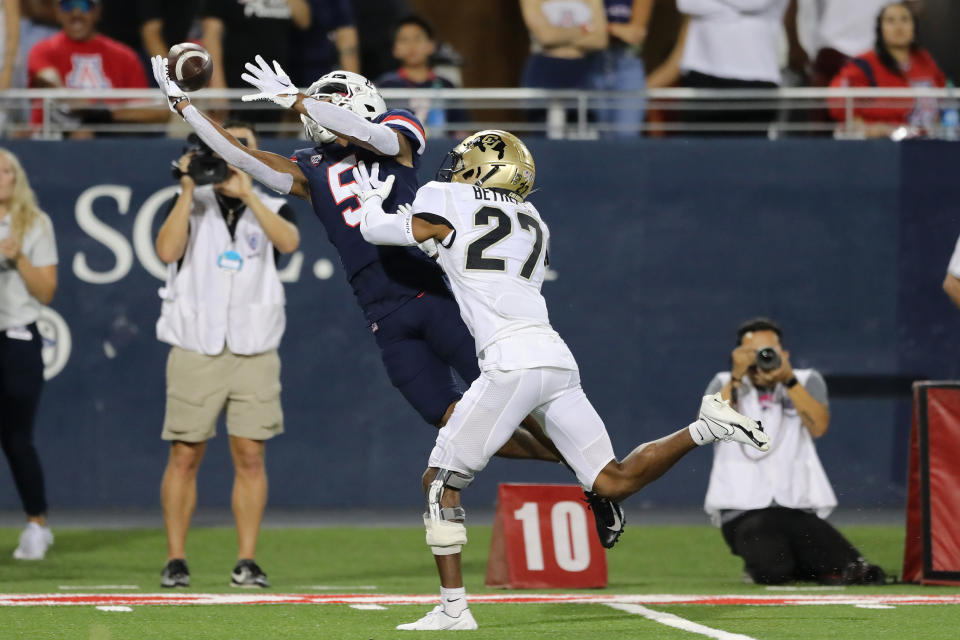 TUCSON, ARIZONA – OCTOBER 01: Wide receiver Dorian Singer #5 of the Arizona Wildcats catches a pass despite cornerback Nigel Bethel Jr. #27 of the Colorado Buffaloes during the first half of the NCAA football game at Arizona Stadium on October 01, 2022 in Tucson, Arizona. (Photo by Rebecca Noble/Getty Images)