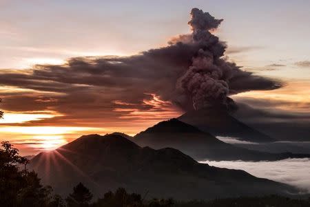 Mount Agung volcano is seen spewing smoke and ash in Bali, Indonesia, November 26, 2017 in this picture obtained from social media. EMILIO KUZMA-FLOYD/via REUTERS