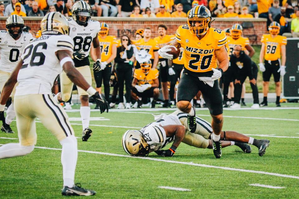 Missouri running back Cody Schrader (20) sheds a tackle from Vanderbilt's Jaylen Mahoney (23) during the Tigers' 17-14 win over the Commodores on Oct. 22, 2022.