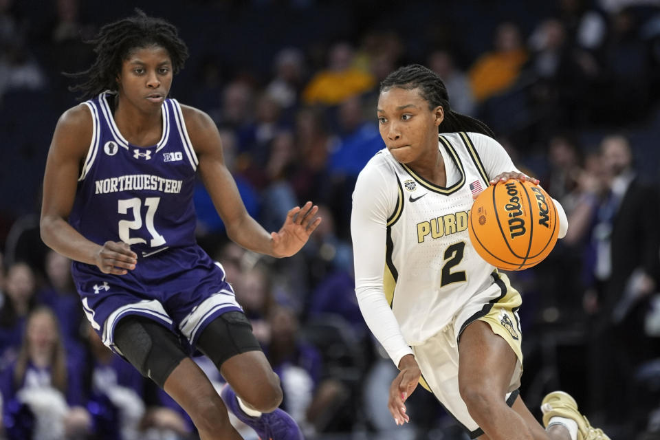 Purdue guard Rashunda Jones (2) works toward the basket as Northwestern guard Melannie Daley (21) defends during the second half of an NCAA college basketball game at the Big Ten women's tournament Wednesday, March 6, 2024, in Minneapolis. (AP Photo/Abbie Parr)
