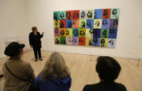 In this photo taken Wednesday, May 15, 2019, Donna DeSalvo, deputy director and senior curator at New York's Whitney Museum of American Art, talks about the piece "Ethel Scull 36 Times" displayed in the exhibition "Andy Warhol _ From A to B and Back Again" in San Francisco. A retrospective of Andy Warhol's work on display at the San Francisco Museum of Modern Art captures his use of artwork to give his subjects personas the way people do now using social media. (AP Photo/Eric Risberg)