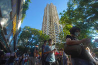 People queue up to vote in Hong Kong Sunday, July 12, 2020, in an unofficial primary for pro-democracy candidates ahead of legislative elections in September. Over 200,000 Hong Kongers voted in an unofficial Hong Kong primary that will help the pro-democracy camp decide which candidates to field in legislative elections in September. The turnout exceeded organizers' estimates that some 170,000 people would turn up to vote over the weekend. (AP Photo/Vincent Yu)