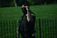 A member of the US Secret Service takes up position outside the Brady Briefing Room as the White House is locked down in Washington, DC, on August 10, 2020. - Secret Service guards shot a person, who was apparently armed, outside the White House on August 10, 2020. President Donald Trump said just after being briefly evacuated in the middle of a press conference. (Photo by Brendan Smialowski / AFP) (Photo by BRENDAN SMIALOWSKI/AFP via Getty Images)