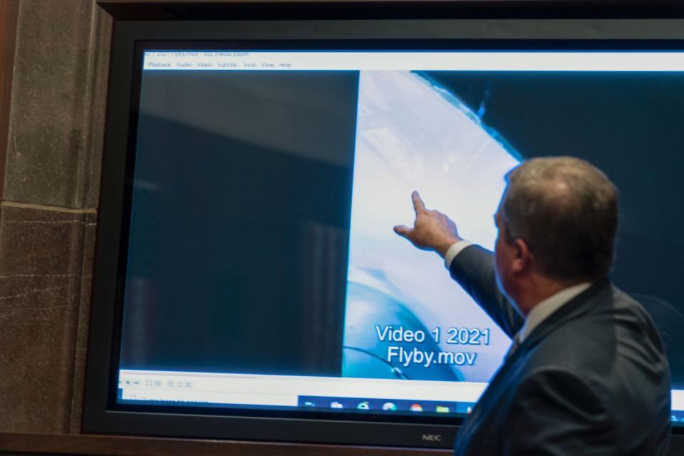 Deputy Director of Naval Intelligence Scott Bray points to a video display of a UAP