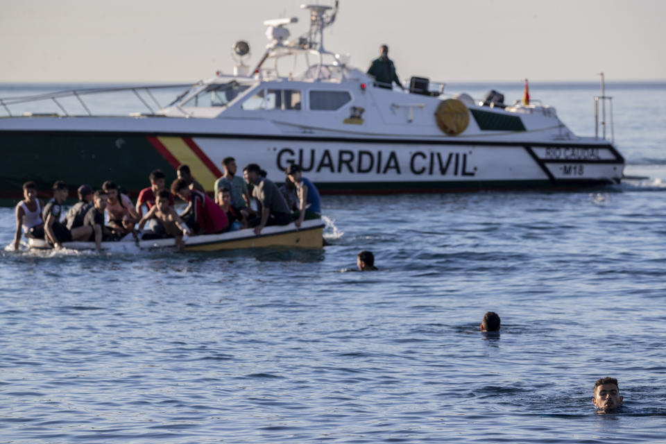 Migrants arrive at the Spanish enclave of Ceuta, near the border of Morocco and Spain, Wednesday, May 19, 2021. Spanish officials are acknowledging for the first time that the unprecedented migrant crisis has been triggered by an angry Rabat at Madrid's decision to provide medical treatment to the militant boss of the Polisario Front. (AP Photo/Bernat Armangue)