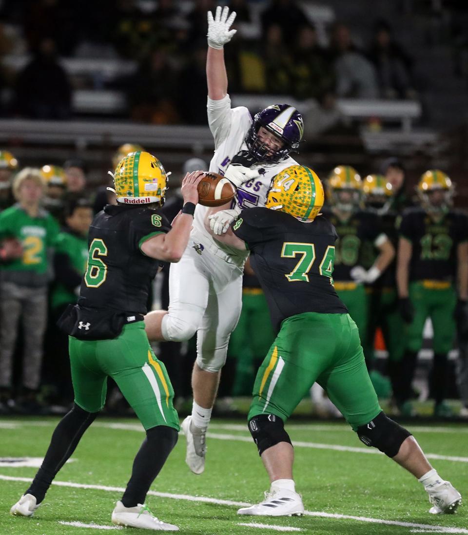 North Kitsap's James Rebman (55) fights off a block by Lynden's Josiah VanderHaak (74) and is able to block a pass by quarterback Brant Heppner (6) during their championship game in Puyallup on Saturday, Dec. 3, 2022.