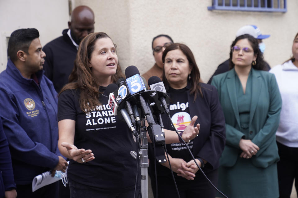 Lindsay Toczylowski, executive director at Immigrant Defenders Law Center, left at podium, and Angelica Salas, executive director of CHIRLA, the Coalition for Humane Immigrant Rights, talk to reporters gathered outside St. Anthony's Croatian Catholic Church in the Chinatown area of Los Angeles on Wednesday, June 14, 2023. A group of migrants, including some children, who arrived by bus from Texas, were dropped off at Union Station Wednesday and were being cared for at the church. Texas Gov. Greg Abbott said the migrants were sent to Los Angeles because California had declared itself a "sanctuary" for immigrants. (AP Photo/Damian Dovarganes)