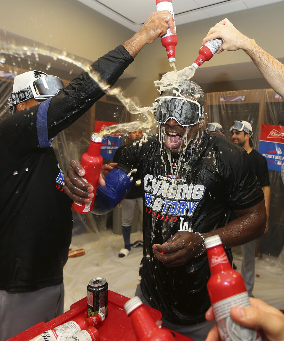 Los Angeles Dodgers' Yasiel Puig is doused after Game 4 of baseball's National League Division Series against the Atlanta Braves, Monday, Oct. 8, 2018, in Atlanta. The Los Angeles Dodgers won 6-2. (AP Photo/John Bazemore)