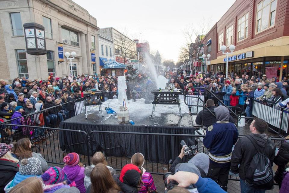 A crowd watches ice carvers during a previous Magical Ice Fest in downtown St. Joseph.