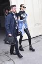 <p>In a graphic tee under an oversized denim jacket tied at the waist with a stripped belt, skinny leather pants and Dr. Martens boots with Karen Walker sunglasses while leaving the Chanel show in Paris. </p>