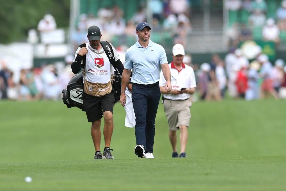 Rory McIlroy, center, walks down the 10th fairway for his second shot during second round action of the Wells Fargo Championship at Quail Hollow Club in Charlotte, NC on Friday, May 10, 2024.