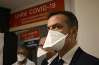 French Health Minister Olivier Veran speaks with medical workers of La Timone public hospital during a visit, Friday Sept. 25, 2020 in Marseille, southeastern France. Angry restaurant and bar owners are demonstrating in Marseille to challenge a French government order to close all public venues as of Saturday to battle resurgent virus infections. On Thursday France reported more than 16,000 new infections, and more than 10% of intensive care beds nationwide are now occupied by COVID-19 patients. (Christophe Simon, Pool via AP)
