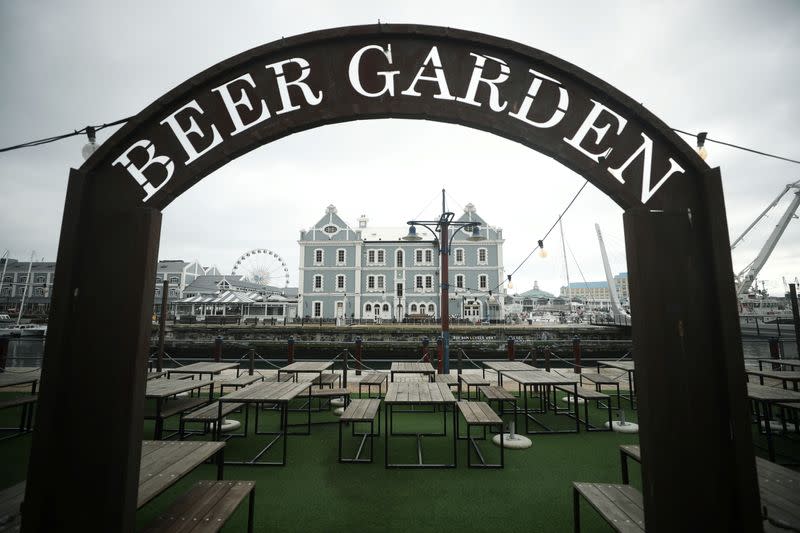 Empty tables are seen at a beer garden in the popular Waterfront district in Cape Town