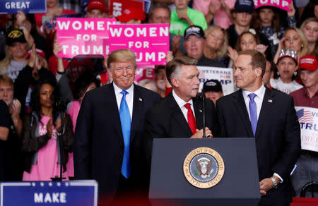 Mark Harris, Republican candidate from North Carolina's 9th Congressional district speaks as U.S. President Donald Trump and Ted Budd, Republican candidate from North Carolina's 13th district look on during a campaign rally in Charlotte, North Carolina, U.S., October 26, 2018. REUTERS/Kevin Lamarque