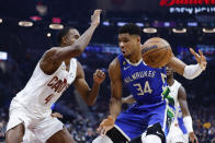 Milwaukee Bucks forward Giannis Antetokounmpo (34) drives against Cleveland Cavaliers forward Evan Mobley (4) during the first half of an NBA basketball game Wednesday, Dec. 21, 2022, in Cleveland. (AP Photo/Ron Schwane)