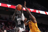 Washington State forward Mouhamed Gueye, left, shoots as Southern California forward Kijani Wright defends during the first half of an NCAA college basketball game Thursday, Feb. 2, 2023, in Los Angeles. (AP Photo/Mark J. Terrill)