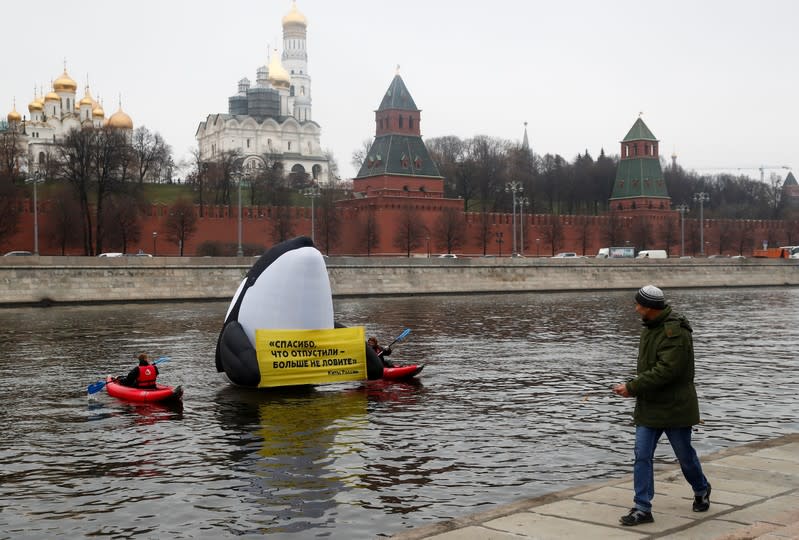 Greenpeace activists take part in a protest in front of the Kremlin against animal rights violations, in Moscow