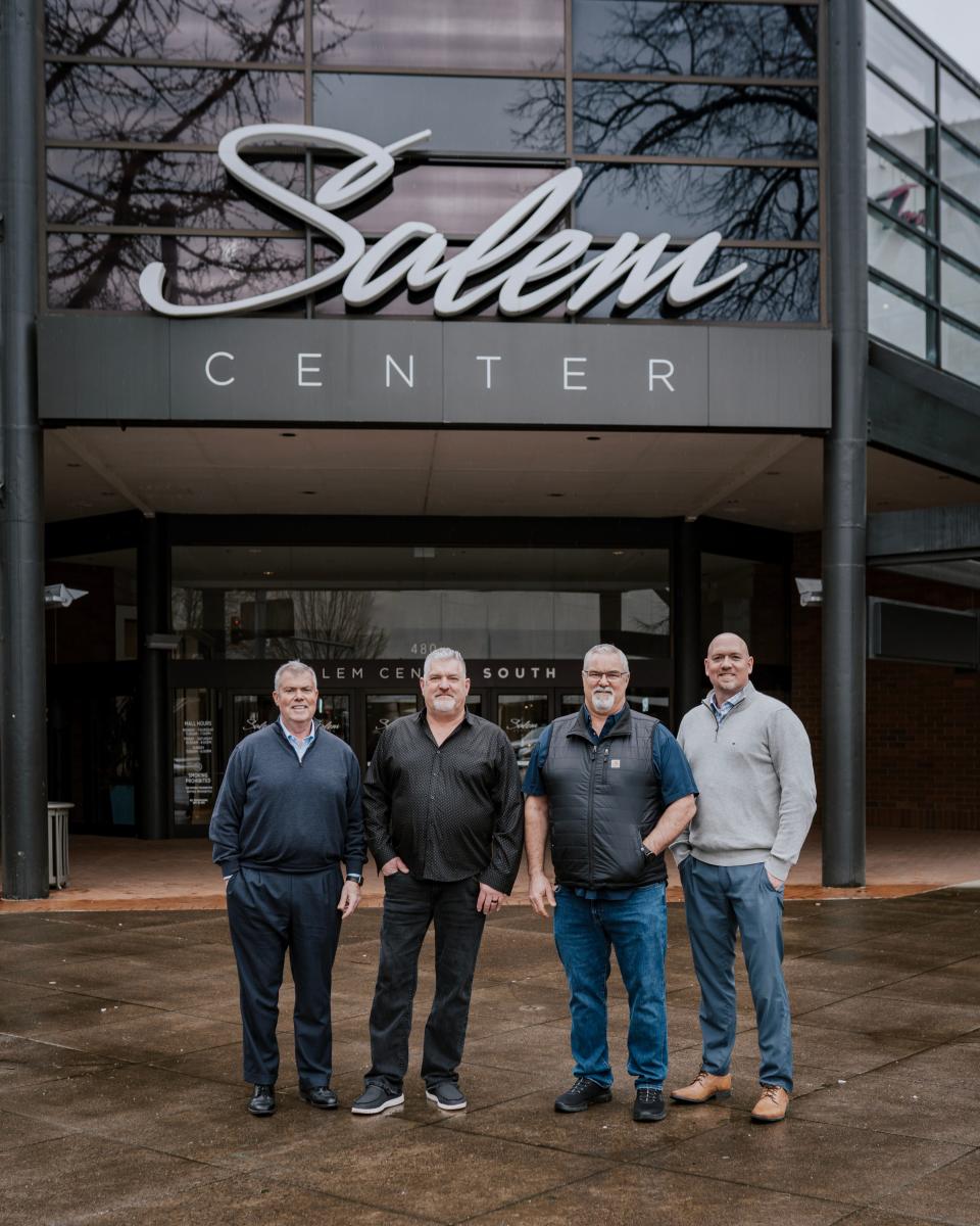The Salem partners buying Salem Center mall, from the left Mark Shipman, Patrick Carney and Kelly McDonald, standing with JLL's Salem Center general manager, Rian Fechte.