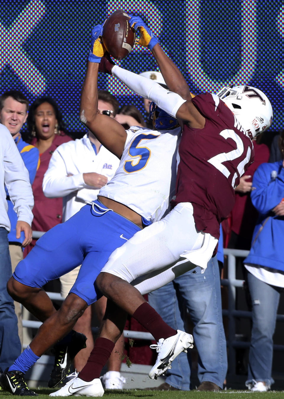 Pittsburgh's Jared Wayne (5) catches a pass from quarterback Kenny Pickett in front of Virginia Tech's Jermaine Waller (25) in the first half of an NCAA college football game, Saturday, Oct. 16, 2021, in Blacksburg, Va. (Matt Gentry/The Roanoke Times via AP)