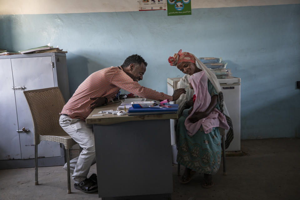 Dr. Tewodros Tefera treats a patient at the Sudanese Red Crescent Clinic in Hamdayet, Sudan, on March 17, 2021. (AP Photo/Nariman El-Mofty)