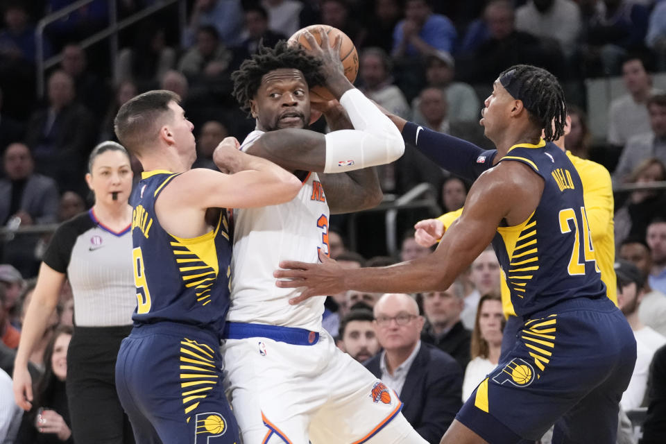 Indiana Pacers guard T.J. McConnell (9) and guard Buddy Hield (24) guard New York Knicks forward Julius Randle in the second half of an NBA basketball game, Wednesday, Jan. 11, 2023, at Madison Square Garden in New York. (AP Photo/Mary Altaffer)