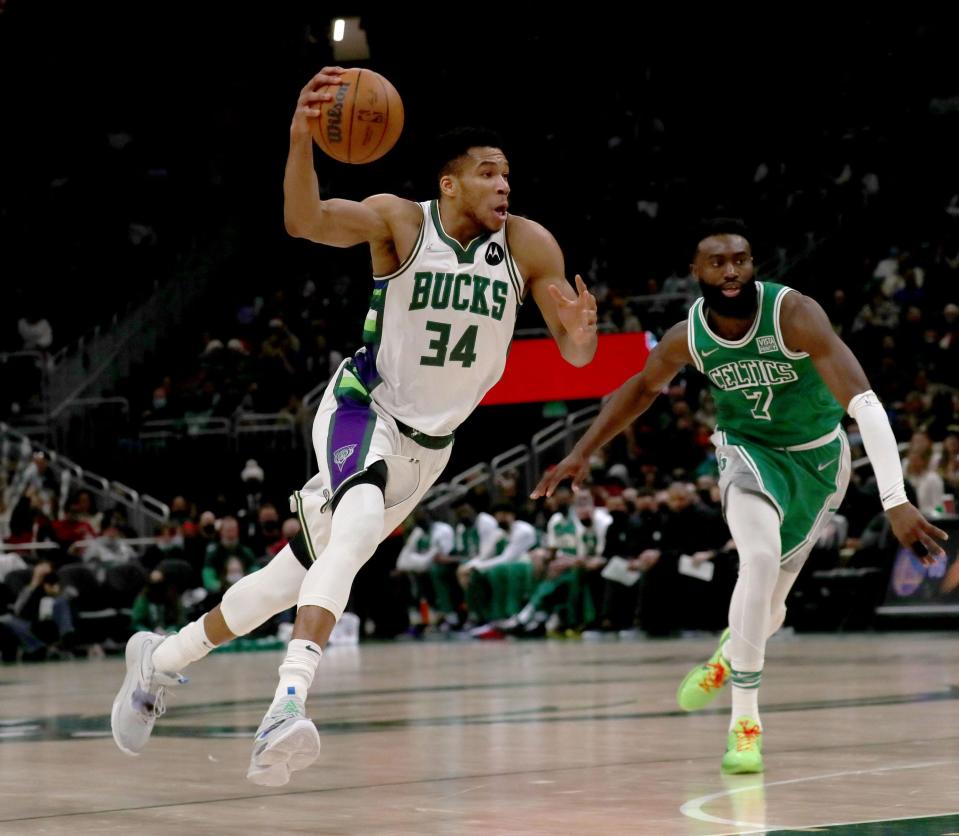 Bucks forward Giannis Antetokounmpo drives past Boston Celtics guard Jaylen Brown during a 117-113 Milwaukee victory Dec. 13 at Fiserv Forum.