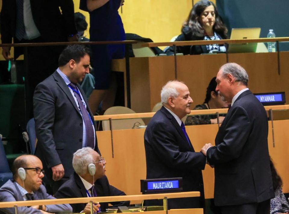 Palestinian Permanent Representative to the UN, Riyad Mansour, accepts the congratulations.