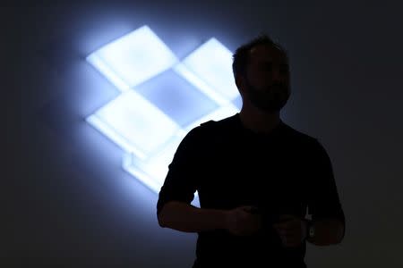 Drew Houston, Chief Executive Officer and founder of Dropbox, stands in front of the company's logo at an announcement event in San Francisco, California, U.S., January 30, 2017. REUTERS/Beck Diefenbach - RTX2YW3U