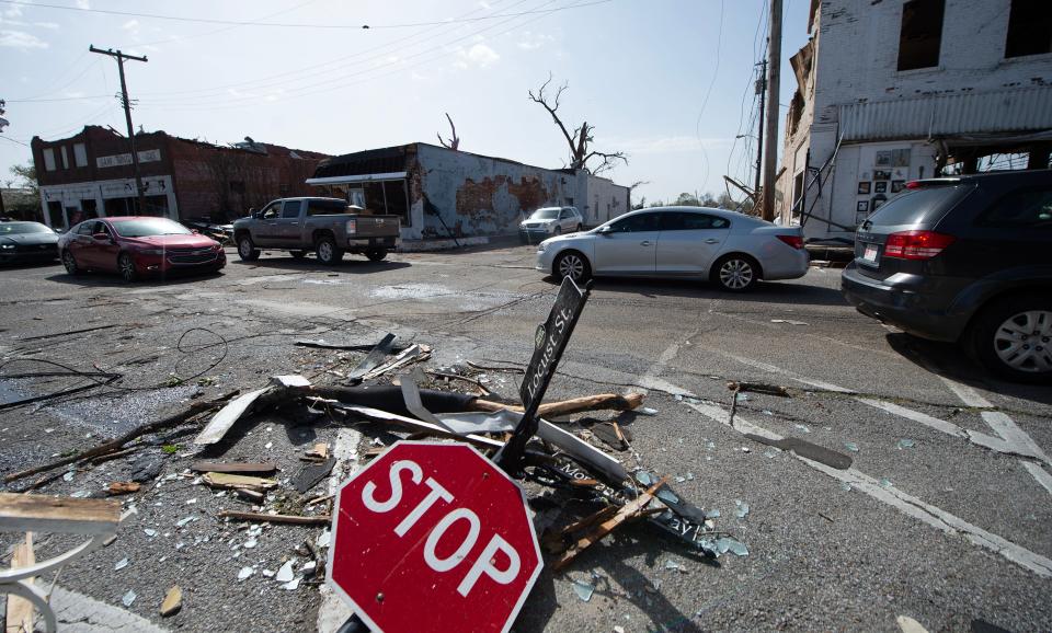 March 25, 2023/Clarion Ledger file photo — Vehicles slowly pass through the intersection of Locus Street and Robert Morganfield Way in Rolling Fork, Miss., Saturday, March 25, 2023, after a tornado cut through the small Delta town Friday night.