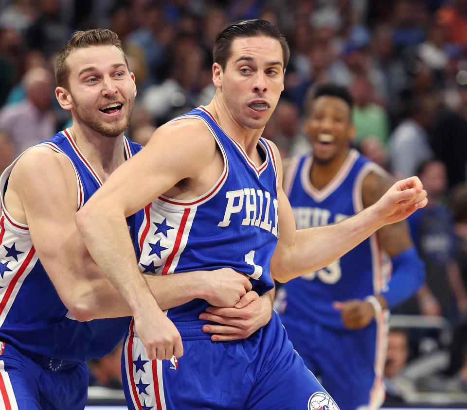 Nik Stauskas holds on tight to Philadelphia's meal ticket, elite closer T.J. McConnell. (Stephen M. Dowell/Orlando Sentinel/TNS/Getty Images)