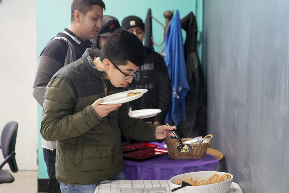 Jefferson Martinez smells the chipotle arroz con pollo before trying the dish as Mount Diablo High School students participated in a taste test in Concord, Calif., Friday, Jan. 13, 2023. (AP Photo/Godofredo A. Vásquez)