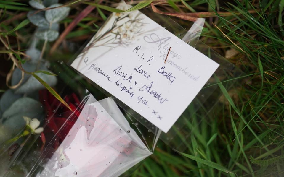 Floral tributes outside the church in Thriplow - Joe Giddens/PA