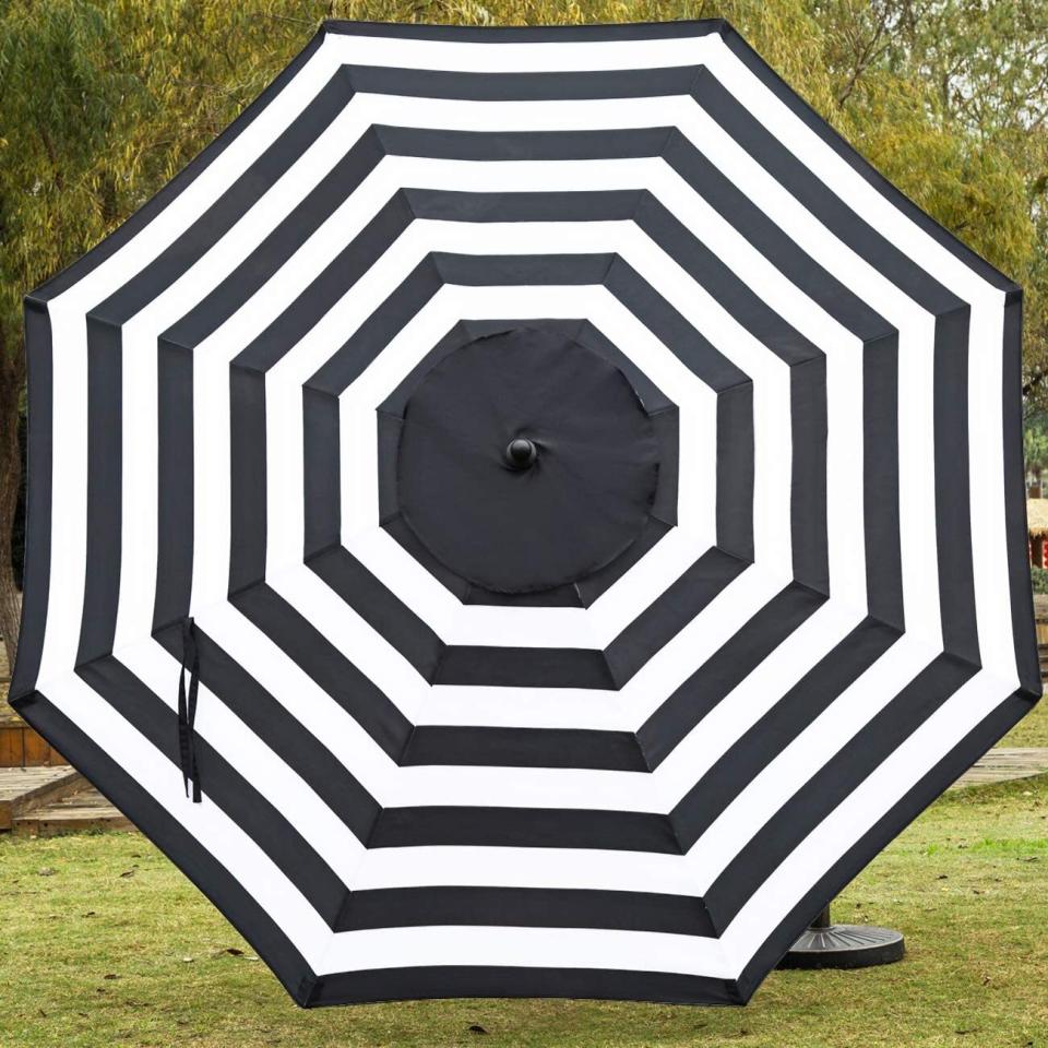 You'll be sure to get plenty of shade from the sun when it's hot outside with this cute umbrella. It's adjustable and you can move it from side to side to help you stay cool and sunburn-free while you're eating or lounging. <br /><br /><strong>Promising review:</strong> "I got the red umbrella for my deck. It is big, beautiful, and the perfect color for good shade on a sunny afternoon. My deck is on the west side of my home and gets direct sun. <strong>This umbrella is exactly what I needed. The dark red provides nice shade for relaxing at the table with your favorite beverage and snack.</strong> The easy put up and take down is a plus for enjoyment." &mdash; <a href="https://amzn.to/32H12YG" target="_blank" rel="nofollow noopener noreferrer" data-skimlinks-tracking="5580838" data-vars-affiliate="Amazon" data-vars-href="https://www.amazon.com/gp/customer-reviews/R1NVOSI217YVO5?tag=bfgenevieve-20&amp;ascsubtag=5580838%2C20%2C33%2Cmobile_web%2C0%2C0%2C1159950" data-vars-keywords="cleaning,fast fashion" data-vars-link-id="1159950" data-vars-price="" data-vars-product-id="16176892" data-vars-retailers="Amazon">Amazon Customer</a><br /><br /><strong>Get it from Amazon for <a href="https://amzn.to/2Qr99Wv" target="_blank" rel="nofollow noopener noreferrer" data-skimlinks-tracking="5580838" data-vars-affiliate="Amazon" data-vars-asin="B07L1Q51XC" data-vars-href="https://www.amazon.com/dp/B07L1Q51XC?tag=bfgenevieve-20&amp;ascsubtag=5580838%2C20%2C33%2Cmobile_web%2C0%2C0%2C1159946" data-vars-keywords="cleaning,fast fashion" data-vars-link-id="1159946" data-vars-price="" data-vars-product-id="7673396" data-vars-product-img="https://m.media-amazon.com/images/I/31REFWyhfuL.jpg" data-vars-product-title="Sunnyglade 9' Patio Umbrella Outdoor Table Umbrella with 8 Sturdy Ribs (Balck and White)" data-vars-retailers="Amazon">$48.99</a> (available in seven colors).</strong>