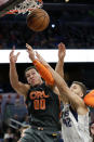 Orlando Magic forward Aaron Gordon (00) battles Dallas Mavericks forward Maxi Kleber (42) for a rebound during the second half of an NBA basketball game, Friday, Feb. 21, 2020, in Orlando, Fla. (AP Photo/John Raoux)