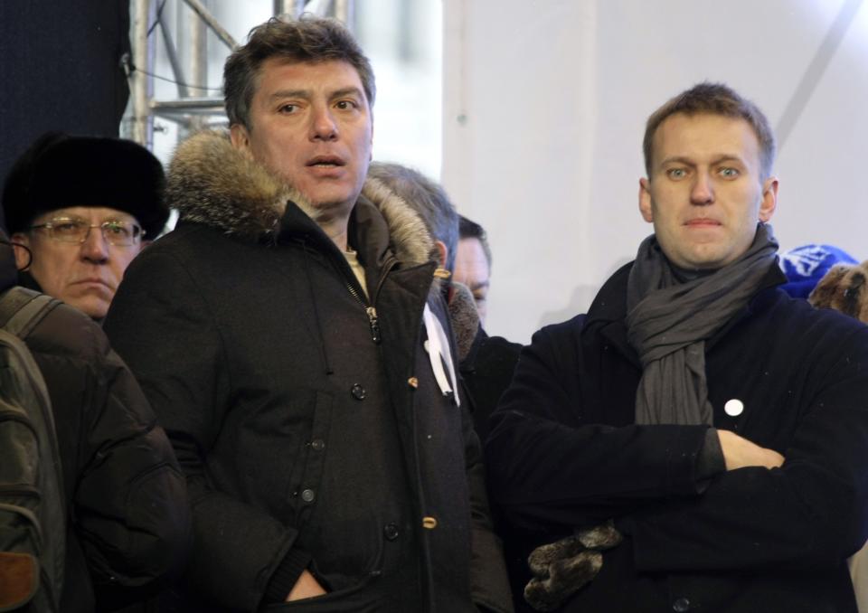 FILE - From left, former Russian Financial Minister Alexei Kudrin and opposition leaders Boris Nemtsov and Alexei Navalny attend a rally in Moscow, Russia, on Saturday Dec. 24, 2011, to protest alleged vote rigging in parliamentary elections. Nemtsov was later shot to death and Navalny was imprisoned. (AP Photo/Misha Japaridze, File)