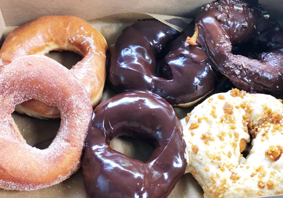 The Sugar Queen doughnuts are so big they barely fit in a box. Clockwise from top left: brown butter glazed, chocolate ganache, mint chocolate glazed, candied maple, chocolate ganache, and cinnamon sugar. June 26, 2020.