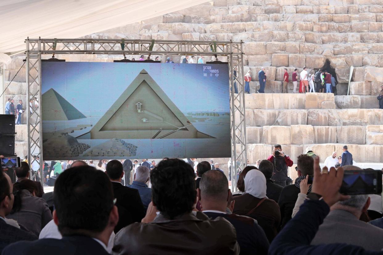 People are waiting for a press conference about a new discovery behind the Khufu Pyramid in Giza, Egypt, on March 2, 2023. A discovery of a nine-meter-long and 2.10-meter-wide corridor behind the Great Pyramid of Giza, known as the Khufu Pyramid, was announced on Thursday. Egyptian Minister of Tourism and Antiquities Ahmed Issa said that "the discovery is a result of the international 'ScanPyramids' project that was launched in 2015 by Egypt's Ministry of Antiquities to study the structure of the pyramids without using harmful drilling methods." Egypt Giza Khufu Pyramid New Corridor Discovery - 02 Mar 2023