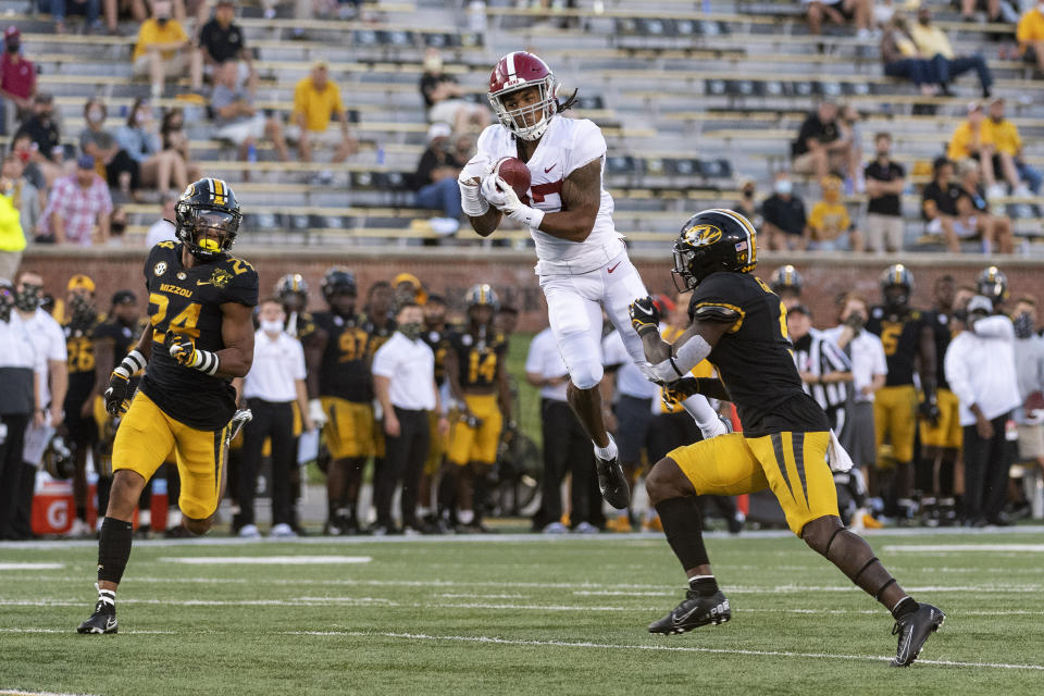 Alabama wide receiver Jaylen Waddle, center, pulls down a reception between Missouri's Tyree Gillespie, right, and Ishmael Burdine, left, during the first quarter of an NCAA college football game Saturday, Sept. 26, 2020, in Columbia, Mo. (AP Photo/L.G. Patterson)