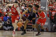 Ohio State's Kyle Young, left, and Jamari Wheeler, right, and Duke's Wendell Moore chase a loose ball during the first half of an NCAA college basketball game Tuesday, Nov. 30, 2021, in Columbus, Ohio. (AP Photo/Jay LaPrete)