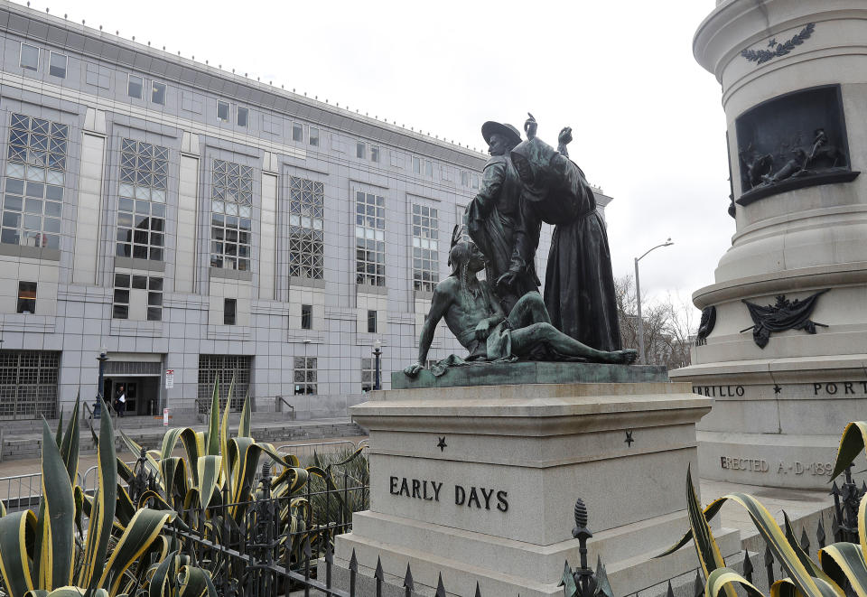 FILE - This March 2, 2018 file photo shows a statue that depicts a Native American at the feet of a Spanish cowboy and Catholic missionary in San Francisco. A San Francisco board has decided to remove the 19th-century statue that activists say is racist and demeaning to indigenous people. The San Francisco Board of Appeals voted Wednesday, Sept. 12, 2018, on the “Early Days” statue. (AP Photo/Jeff Chiu, File)