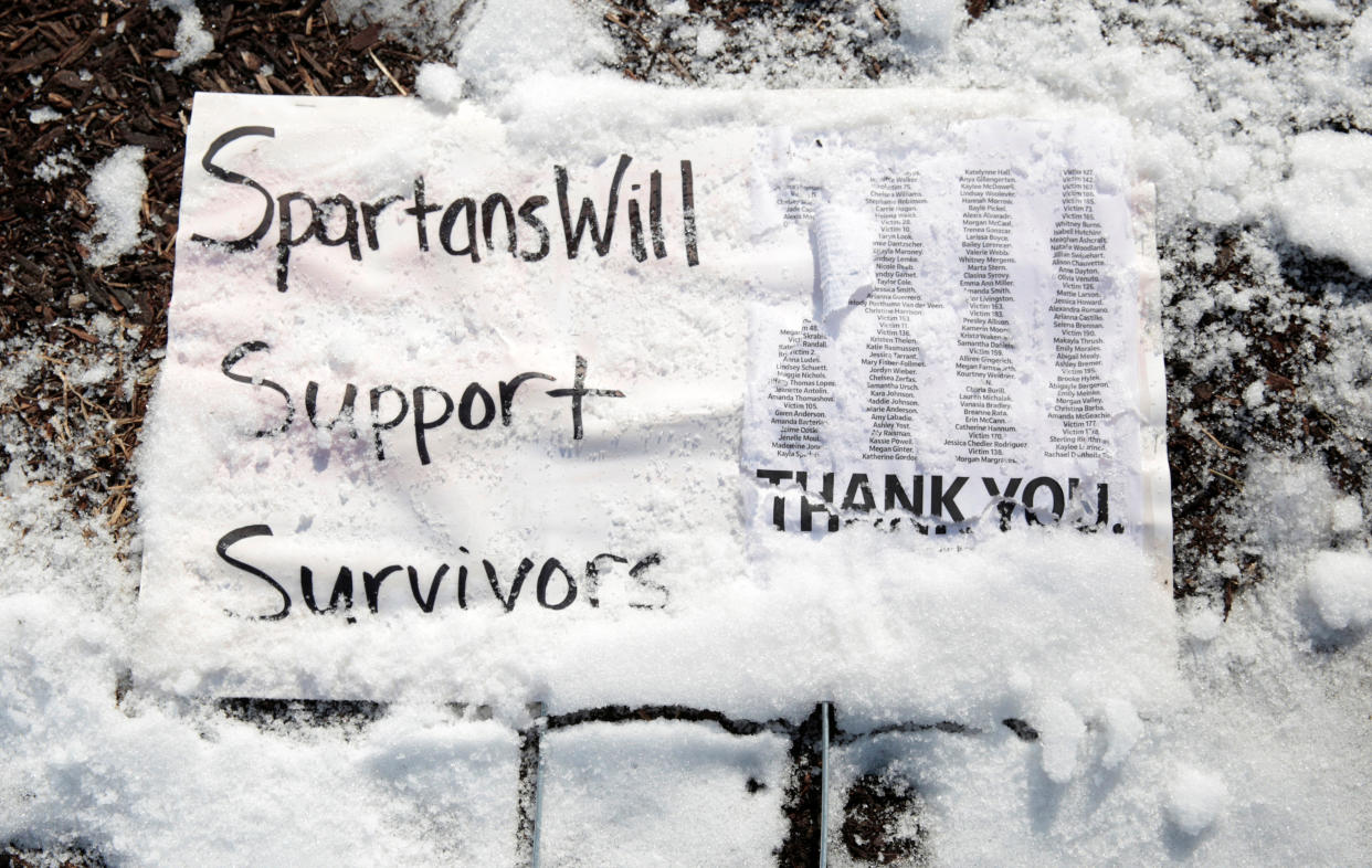 A snow-covered sign on the campus of Michigan State University shows support for the survivors of Larry Nassar's abuse. (Photo: Rebecca Cook/Reuters)