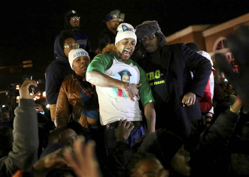 <p>Michael Brown’s stepfather,center, in St. Louis, Missouri on November 14, 2014, urged protesters to ‘Burn this bitch down’ after learning of a grand jury’s decision to not indict Ferguson, Missouri, police officer Darren Wilson. Wilson shot and killed Brown, 18, on August 9. Brown’s stepfather is being criticized for urging the crowd to riot after grand jury decision. (Timothy Tai/ZUMA Wire/ZUMAPRESS.com) </p>